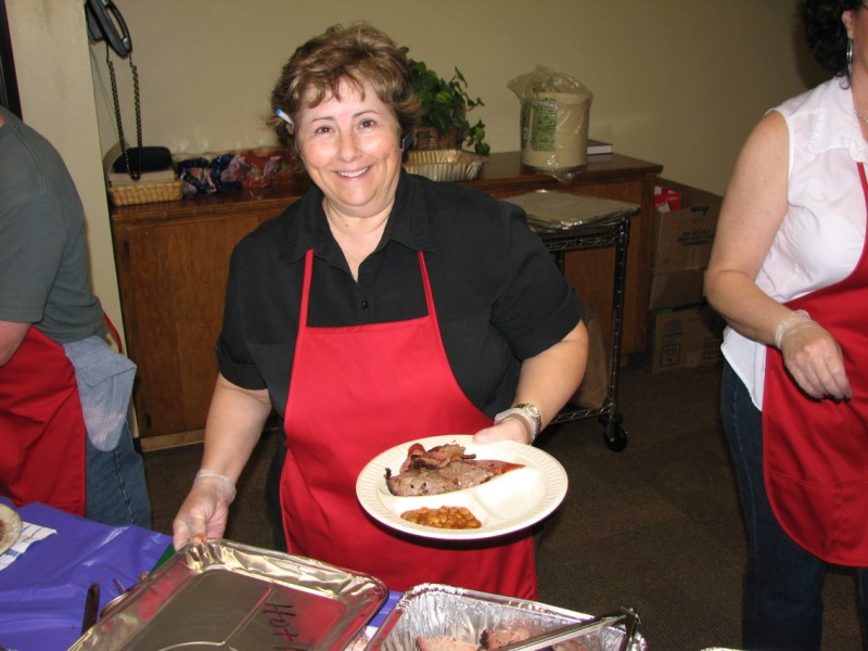 Denise James serves the barbecue.
